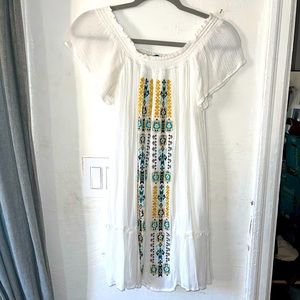 Strapless white dress with embroidered geometric shapes down center of dress.